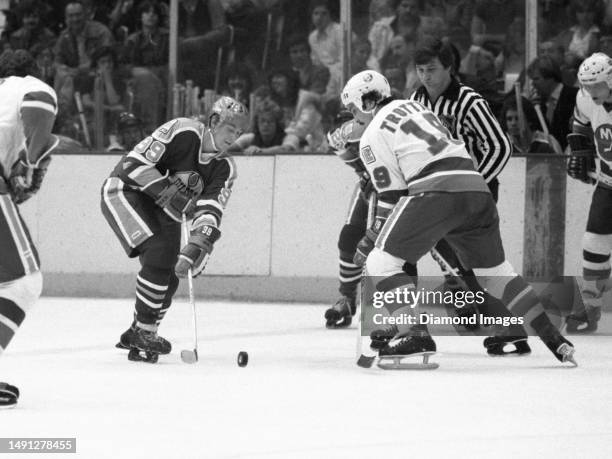 Wayne Gretzky of the Edmonton Oilers faces off against Bryan Trottier of the New York Islanders during a game at the Nassau Coliseum on October 23,...