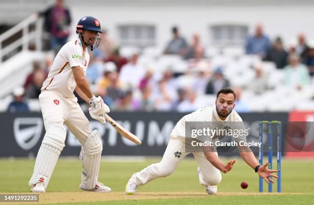 Dane Paterson of Nottinghamshire fields off his own bowling watched by Alastair Cook of Essex during the LV= Insurance County Championship Division 1...