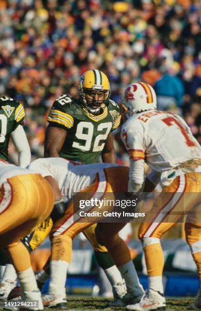 Reggie White, Defensive Tackle and Defensive End for the Green Bay Packers looks over to the Tampa Bay Buccaneers offensive line and Quarterback...