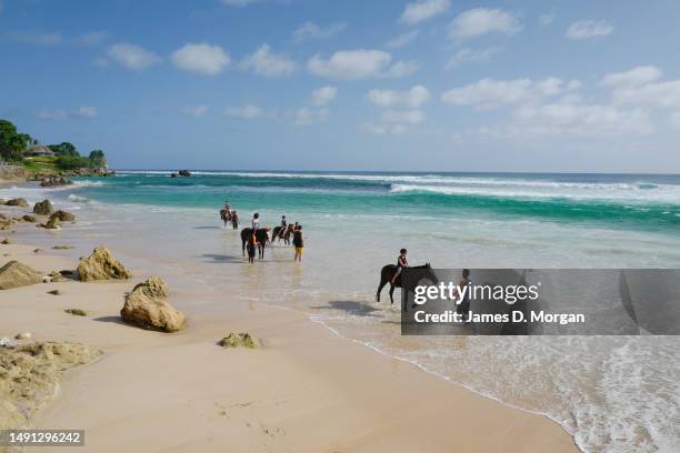 Guests ride and connect with horses in the water next to the main resort of Nihi Sumba on May 01, 2023 in Sumba, Indonesia. Judged as the best hotel...