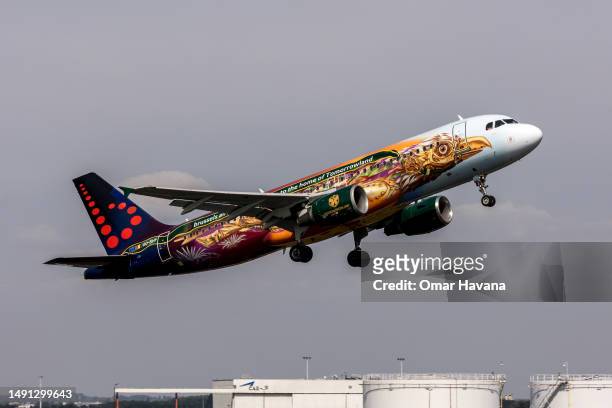Brussels airline plane bound for Porto, painted with the livery of one of the biggest annual electronic dance music festival called Tomorrowland,...