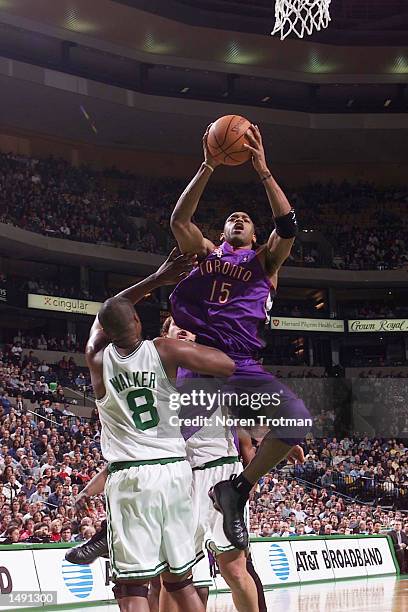 Vince Carter of the Toronto Raptors shoots against Antoine Walker of the Boston Celtics at the Fleet Center in Boston, Massachusetts. DIGITAL IMAGE...