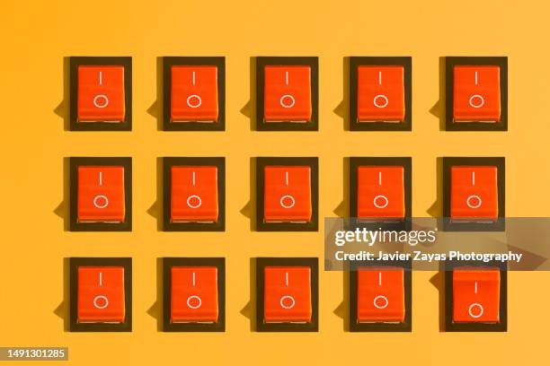some rocker switches on orange background - interruptor fotografías e imágenes de stock