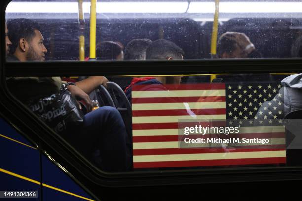 Asylum seekers board a bus en route to a shelter at Port Authority Bus Terminal on May 18 in New York City. Mayor Eric Adams addressed the daily...