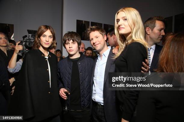 Backstage at the Burberry show during London Fashion Week Autumn/Winter 2016/17, L to R Alexa Chung, Jake Bugg, Burberry Creative Director...