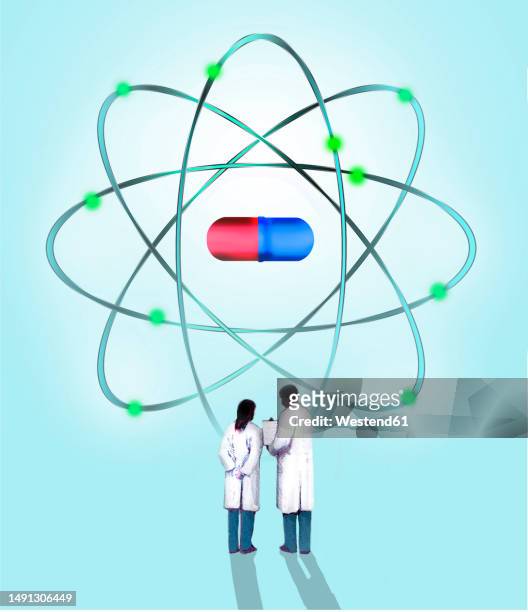 illustration of two scientists talking in front of floating pill - atomic imagery stock illustrations