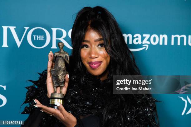 Kamille poses with the award after winning Outstanding Song Collection at The Ivors 2023 at Grosvenor House on May 18, 2023 in London, England.