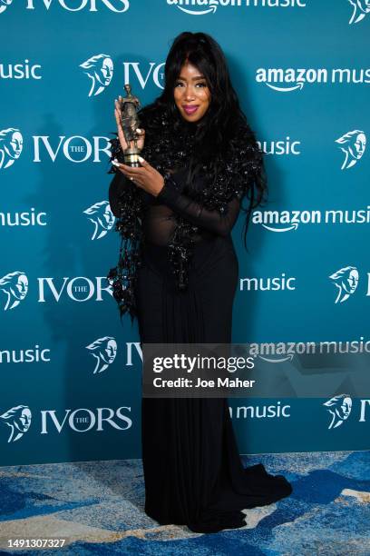 Kamille poses with the award after winning Outstanding Song Collection at The Ivors 2023 at Grosvenor House on May 18, 2023 in London, England.