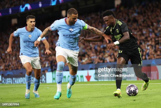 Vinicius Junior of Real Madrid is challenged by Kyle Walker of Manchester City during the UEFA Champions League semi-final second leg match between...