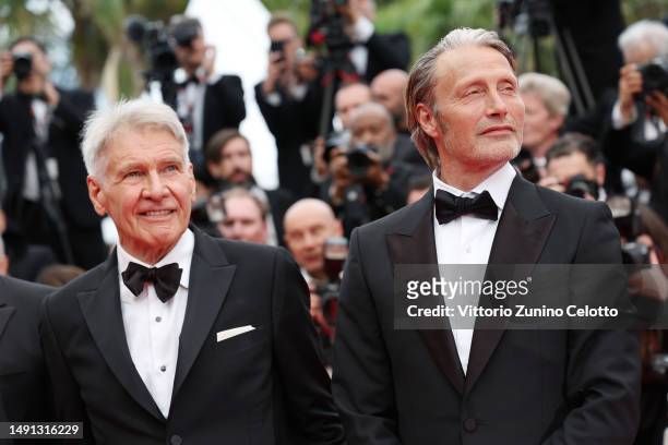 Harrison Ford and Mads Mikkelsen attend the "Indiana Jones And The Dial Of Destiny" red carpet during the 76th annual Cannes film festival at Palais...