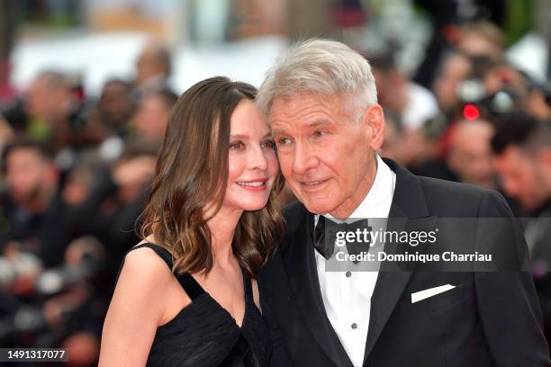 Calista Flockhart and Harrison Ford attend the "Indiana Jones And The Dial Of Destiny" red carpet during the 76th annual Cannes film festival at...