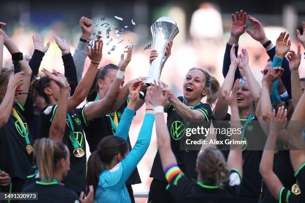 Kathrin Hendrich of VfL Wolfsburg and team mates celebrate with the DFB Cup after winning the Women's DFB Cup Final between VfL Wolfsburg and...