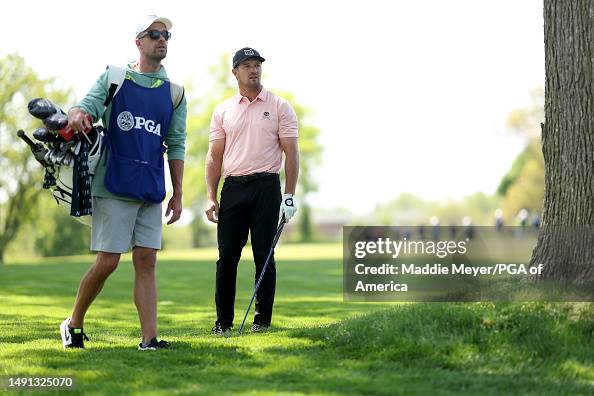 Bryson DeChambeau of the United States waits with his caddie after ...