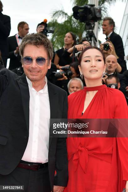 Jean-Michel Jarre and Gong Li attends the "Indiana Jones And The Dial Of Destiny" red carpet during the 76th annual Cannes film festival at Palais...