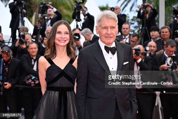 Calista Flockhart and Harrison Ford attend the "Indiana Jones And The Dial Of Destiny" red carpet during the 76th annual Cannes film festival at...