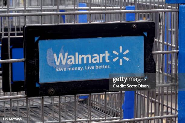 The company logo is shown on the front of shopping cart at a Walmart store on May 18, 2023 in Chicago, Illinois. Walmart, the world's largest...