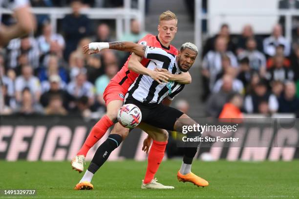 Joelinton of Newcastle United battles for possession with Jan Paul van Hecke of Brighton & Hove Albion during the Premier League match between...