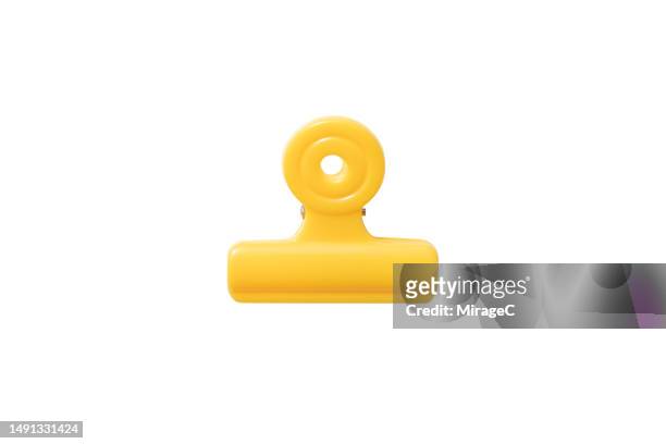 yellow plastic clip isolated on white - binder clip stock-fotos und bilder