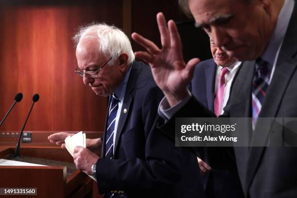 Sen. Bernie Sanders and Sen. Jeff Merkley leave after a news conference on debt limit at the U.S. Capitol on May 18, 2023 in Washington, DC. A group...