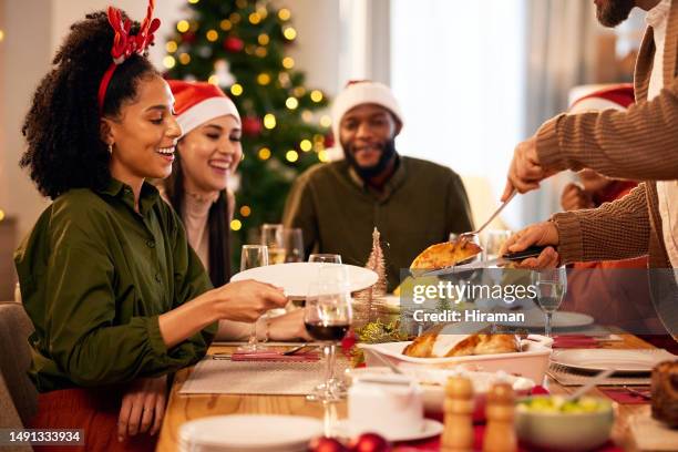 christmas, holiday dinner and party with friends or family for a celebration or event. host serving or cutting chicken for guests to enjoy food, drinking and table together - christmas guest stock pictures, royalty-free photos & images