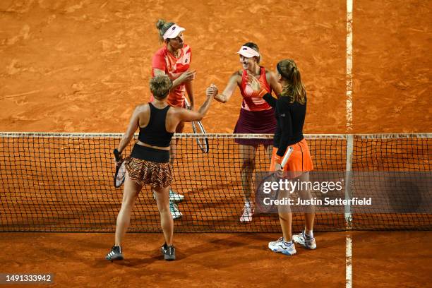 Storm Hunter of Australia and Elise Mertens of Belgium shake hands with Marie Bouzkova of Czech Republic and Bethanie Mattek-Sands of United States...