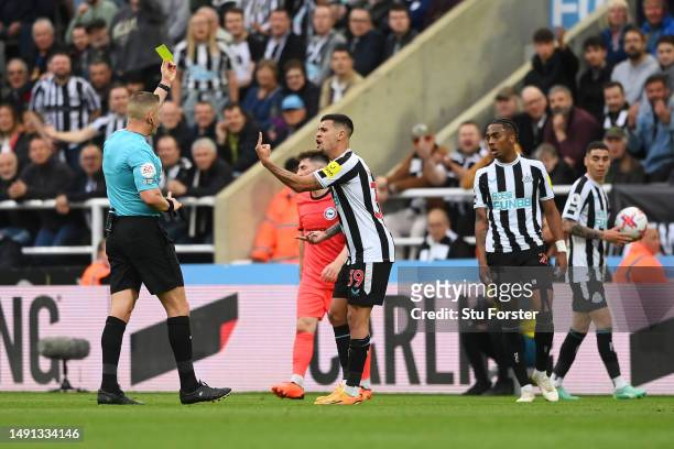 Bruno Guimaraes of Newcastle United is shown a yellow card by Referee Robert Jones during the Premier League match between Newcastle United and...