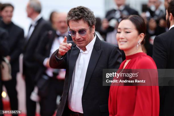 Jean-Michel Jarre and Gong Li attend the "Indiana Jones And The Dial Of Destiny" red carpet during the 76th annual Cannes film festival at Palais des...