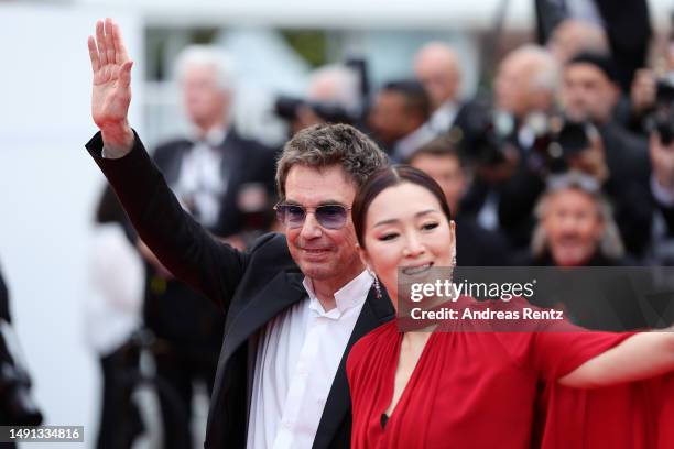 Jean-Michel Jarre and Gong Li attend the "Indiana Jones And The Dial Of Destiny" red carpet during the 76th annual Cannes film festival at Palais des...