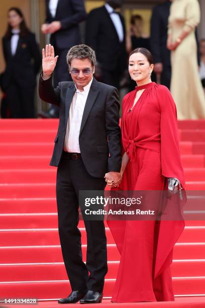 Jean-Michel Jarre and Gong Li attend the "Indiana Jones And The Dial Of Destiny" red carpet during the 76th annual Cannes film festival at Palais des...