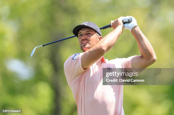 Bryson DeChambeau of The United States plays his tee shot on the par 3, 15th hole during the first round of the 2023 PGA Championship at Oak Hill...