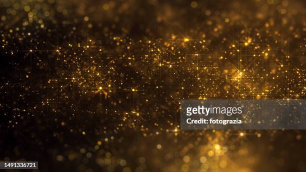 blurred golden particles - first light awards stock-fotos und bilder