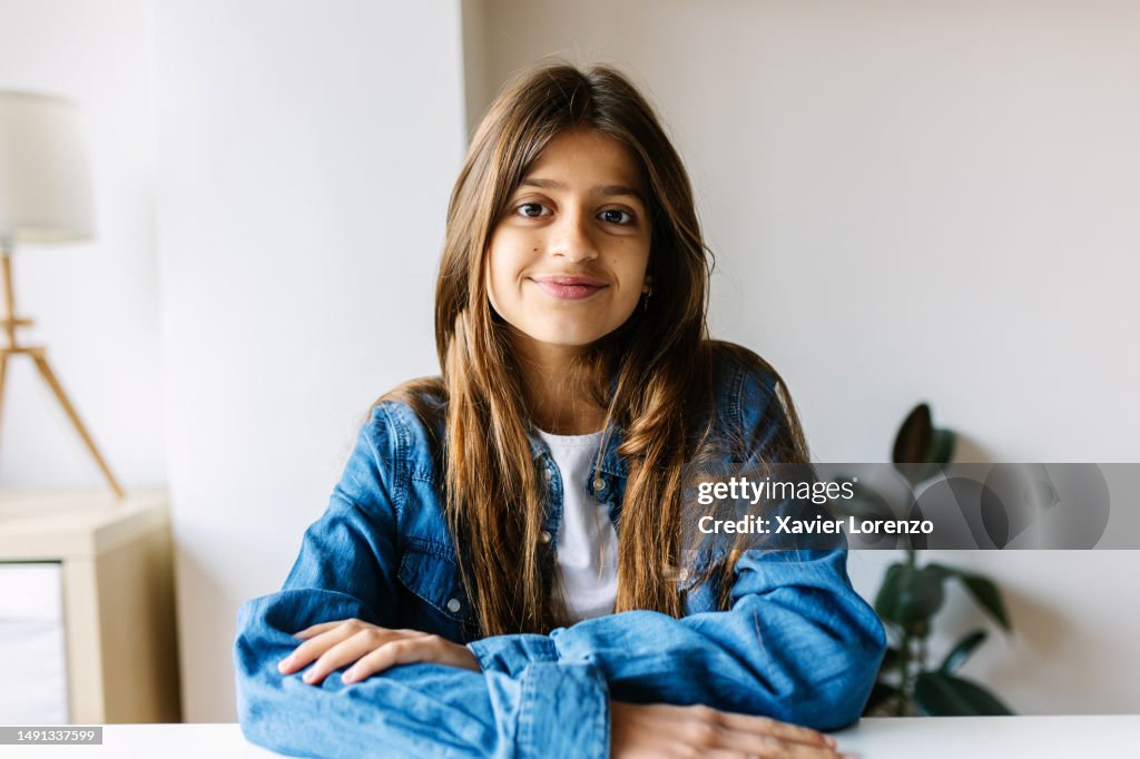 Point of view from camera portrait of young little girl having a video call from home.