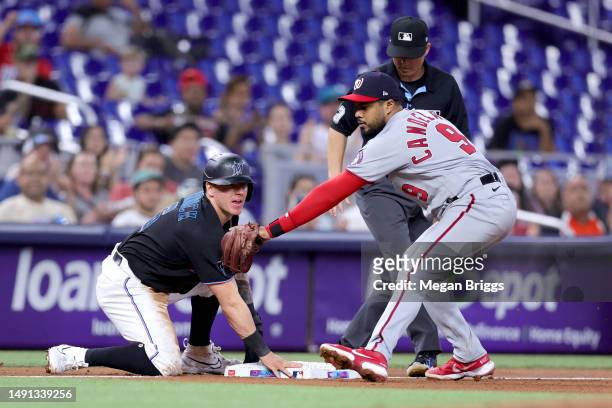 Peyton Burdick of the Miami Marlins slides safe to third base against Jeimer Candelario of the Washington Nationals during the fourth inning at...