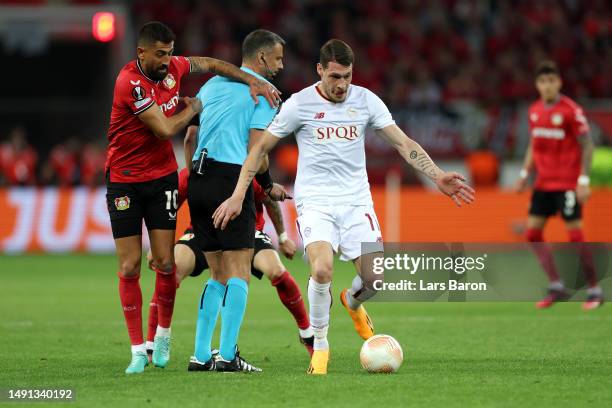 Andrea Belotti of AS Roma controls the ball as Kerem Demirbay of Bayer 04 Leverkusen collides with Referee Slavko Vincic during the UEFA Europa...