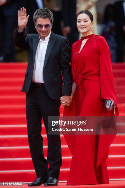 Jean-Michel Jarre and Gong Li attend the "Indiana Jones And The Dial Of Destiny" red carpet during the 76th annual Cannes film festival at Palais des...