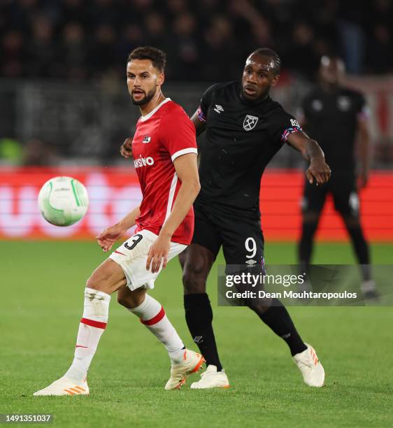 Pantelis Hatzidiakos of AZ Alkmaar passes the ball whilst under pressure from Michail Antonio of West Ham United during the UEFA Europa Conference...