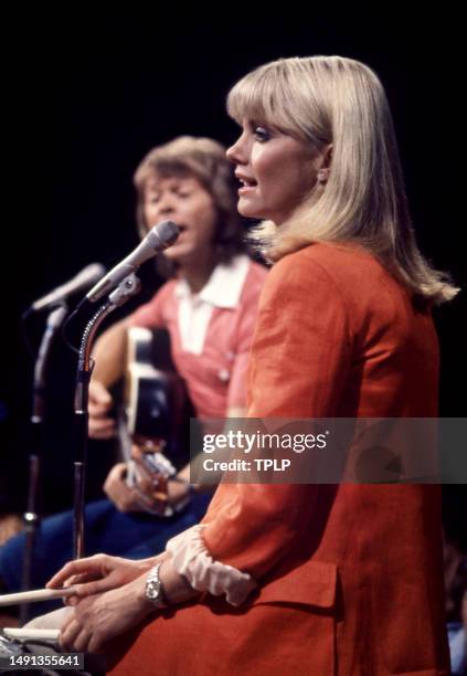 British/Australian singer and actress Olivia Newton-John with Swedish singer and songwriter Björn Ulvaeus, of the supergroup ABBA, perform on stage...