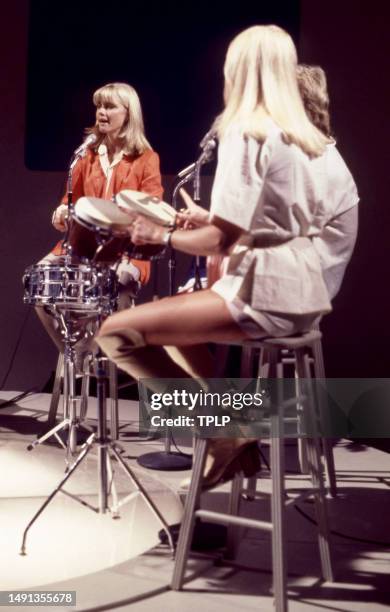 British/Australian singer and actress Olivia Newton-John with Swedish singers and songwriters Björn Ulvaeus and Agnetha Fältskog, of the supergroup...