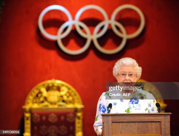 Britain's Queen Elizabeth II speaks at a reception for IOC members at Buckingham Palace in central London on July 23 four days ahead of the opening...