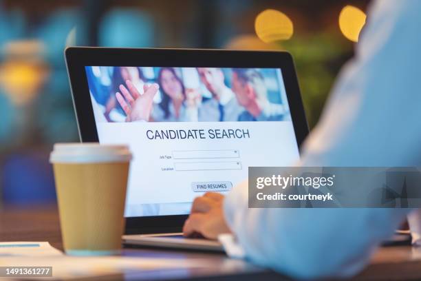 businessman looking at recruitment website on a laptop computer. - werving stockfoto's en -beelden