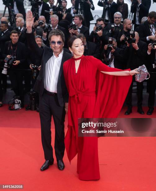 Jean-Michel Jarre and Gong Li attend the "Indiana Jones And The Dial Of Destiny" red carpet during the 76th annual Cannes film festival at Palais des...