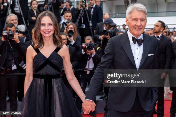 Calista Flockhart and Harrison Ford attend the "Indiana Jones And The Dial Of Destiny" red carpet during the 76th annual Cannes film festival at...