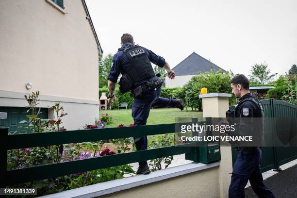 French gendarmes of the PSIG enter a house in a residential area, on July 4 in Montreuil-Juigne, western France, where law enforcement are still...