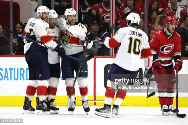 Aleksander Barkov of the Florida Panthers celebrates with Brandon Montour, Carter Verhaeghe and Anthony Duclair after scoring a goal on Frederik...
