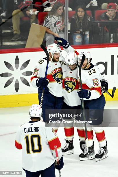 Aleksander Barkov of the Florida Panthers celebrates with Brandon Montour, Carter Verhaeghe and Anthony Duclair after scoring a goal on Frederik...