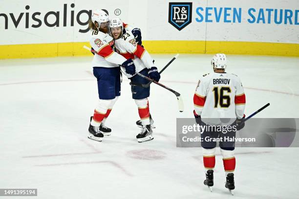 Carter Verhaeghe of the Florida Panthers celebrates with Marc Staal and Aleksander Barkov after scoring a goal on Frederik Andersen of the Carolina...