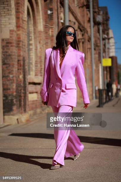 Alice Margot Christie wearing Alex Perry pink suit and Bulgari silver bag at Afterpay Australian Fashion Week 2023 at Carriageworks on May 19, 2023...