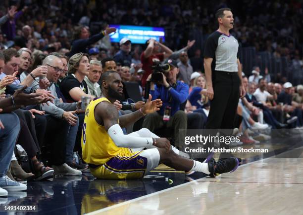 LeBron James of the Los Angeles Lakers reacts after being knocked to the floor during the fourth quarter against the Denver Nuggets in game two of...