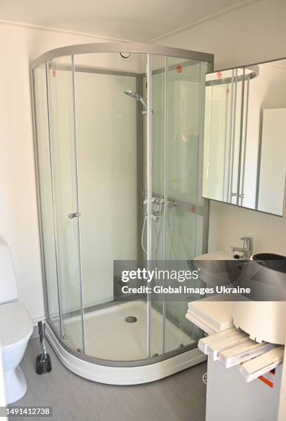 Modular house's bathroom is equipped with a shower cabin on May 13, 2023 in Irpin, Kyiv Oblast, Ukraine. One more modular town for people who lost...