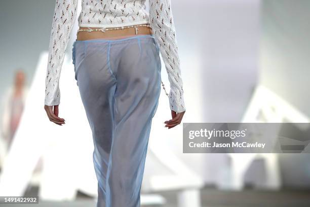 Model walks the runway in a design by Cameron Hill during the Next Gen runway show during Afterpay Australian Fashion Week 2023 at Carriageworks on...